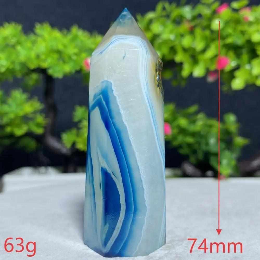 Polished Blue Lace Agate tower featuring calming sky-blue and white banded patterns for throat chakra healing and peace.