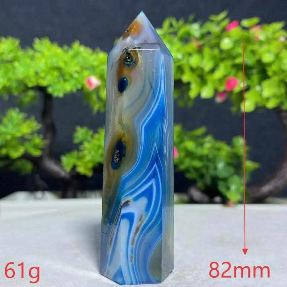 Polished Blue Lace Agate tower featuring calming sky-blue and white bands, perfect for throat chakra healing and peace.