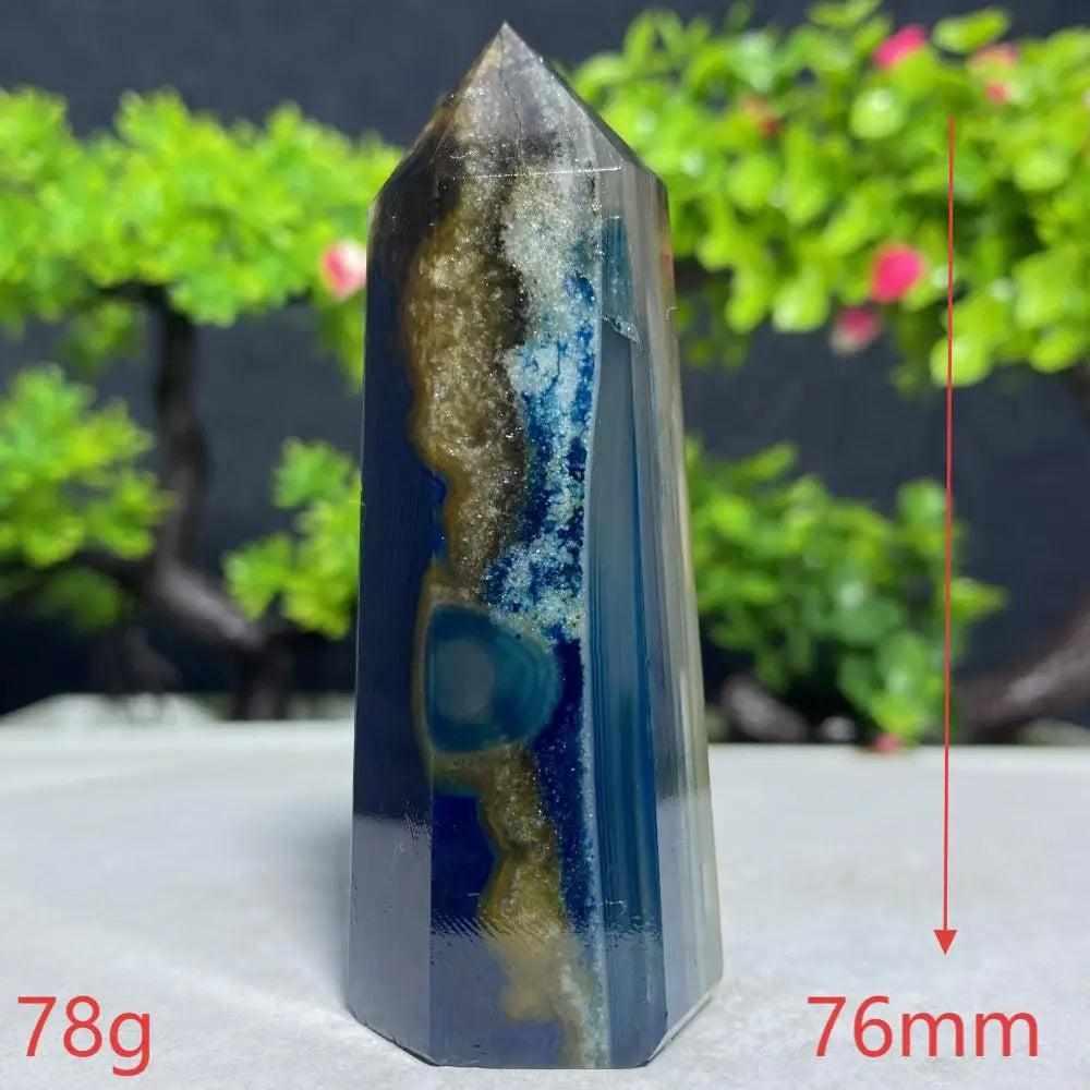 Polished Blue Lace Agate tower featuring deep blue and earthy bands for throat chakra healing and calm communication.