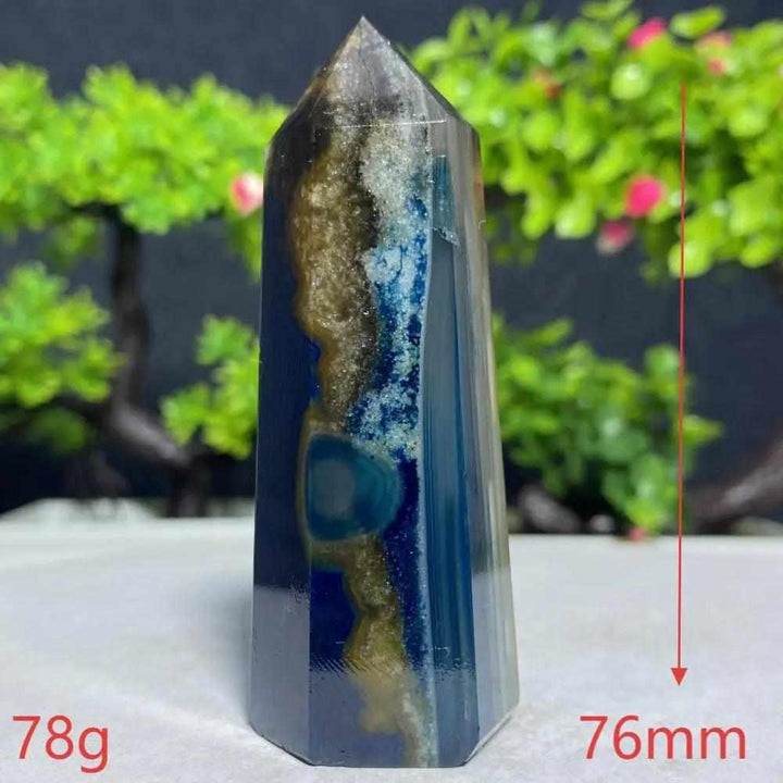 Polished Blue Lace Agate tower featuring deep blue and earthy bands for throat chakra healing and calm communication.