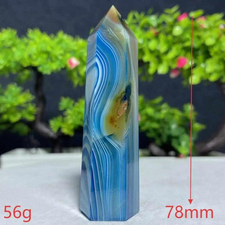 Polished Blue Lace Agate tower featuring calming sky blue and white ripples, perfect for throat chakra healing and peace.