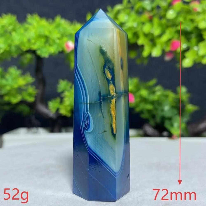 Polished Blue Lace Agate tower with calming sky blue and white bands, perfect for throat chakra healing and tranquility.