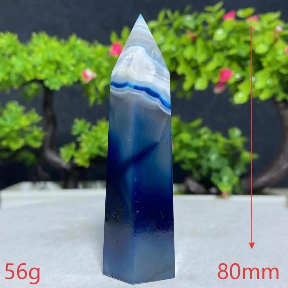 Polished Blue Lace Agate tower with calming sky blue and white bands, perfect for Throat Chakra healing and tranquility.