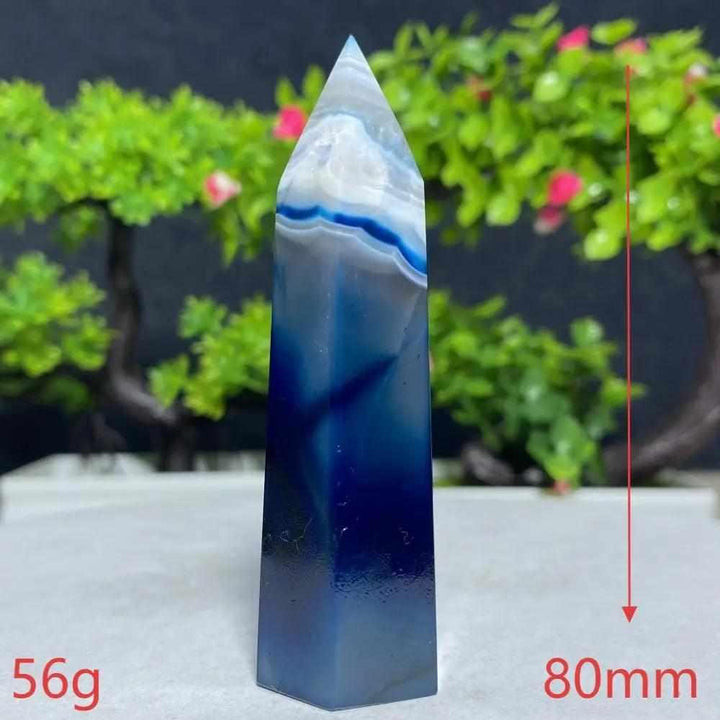 Polished Blue Lace Agate tower with calming sky blue and white bands, perfect for Throat Chakra healing and tranquility.