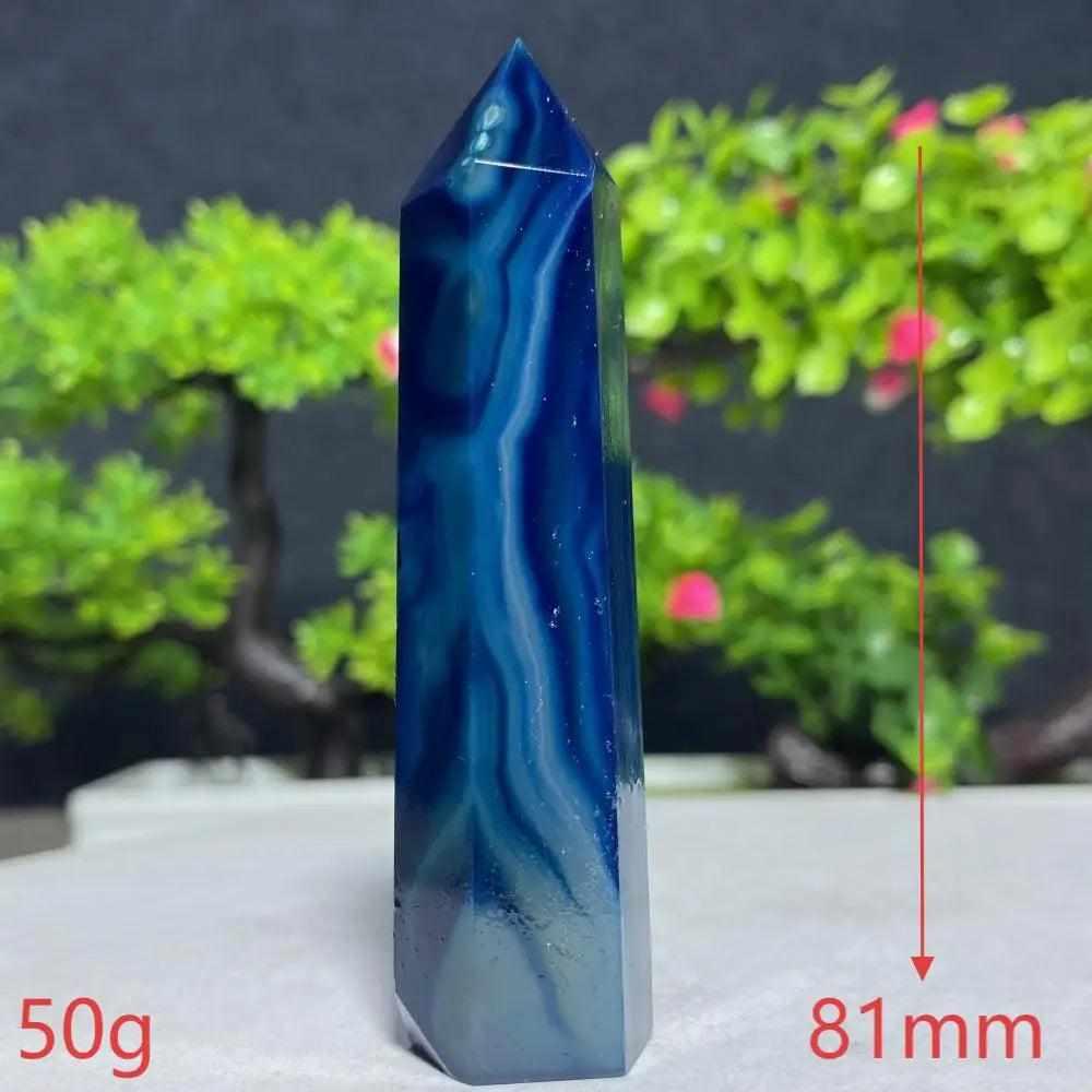 Polished Blue Lace Agate tower featuring calming sky blue and white ripples, ideal for Throat Chakra healing and peace.