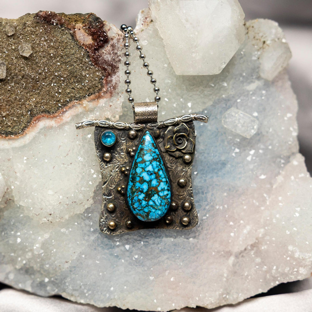 Blue Magnesite 925 Sterling Silver Pendant with a teardrop blue stone, white veining, and decorative silver setting.