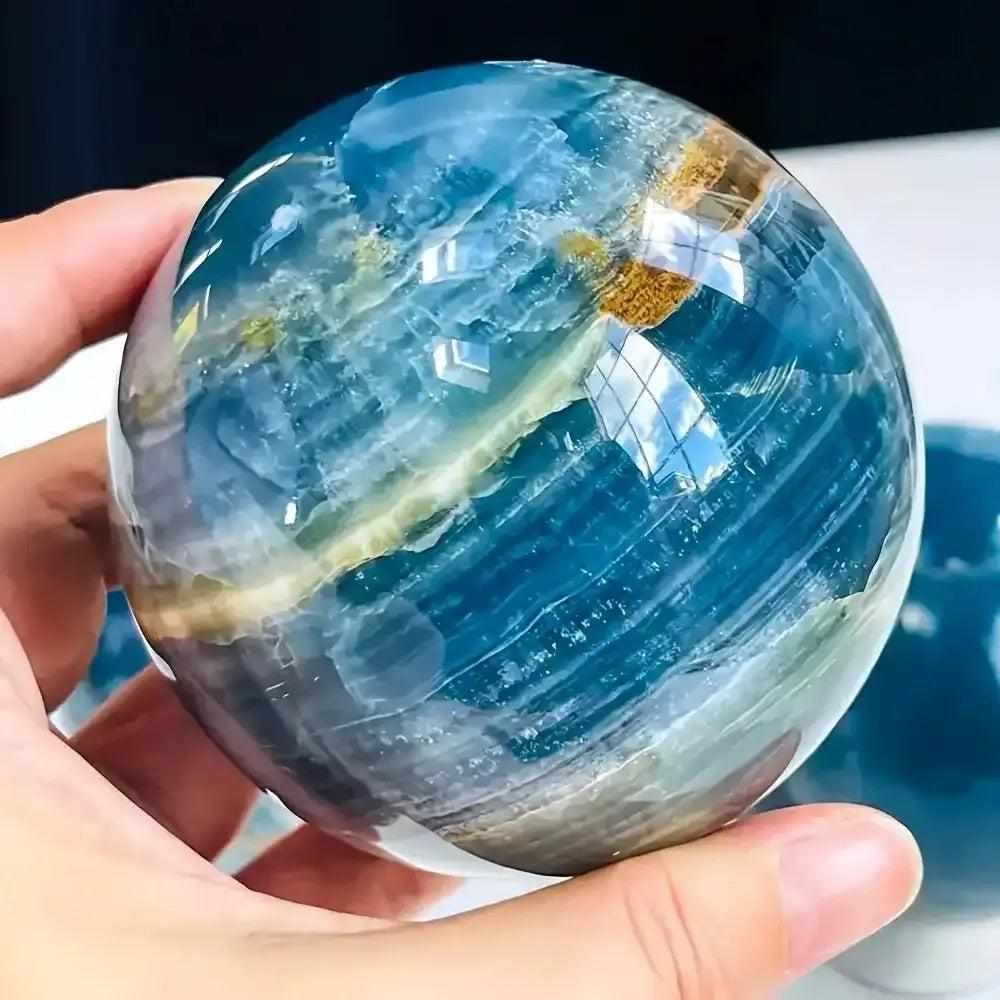 Polished Blue Onyx sphere featuring deep blue layered bands, perfect for Throat and Third Eye chakra meditation.