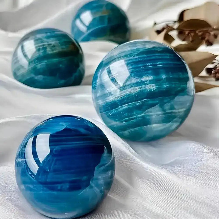 Polished Blue Onyx spheres featuring deep blue layered bands for Throat and Third Eye chakra meditation and focus.