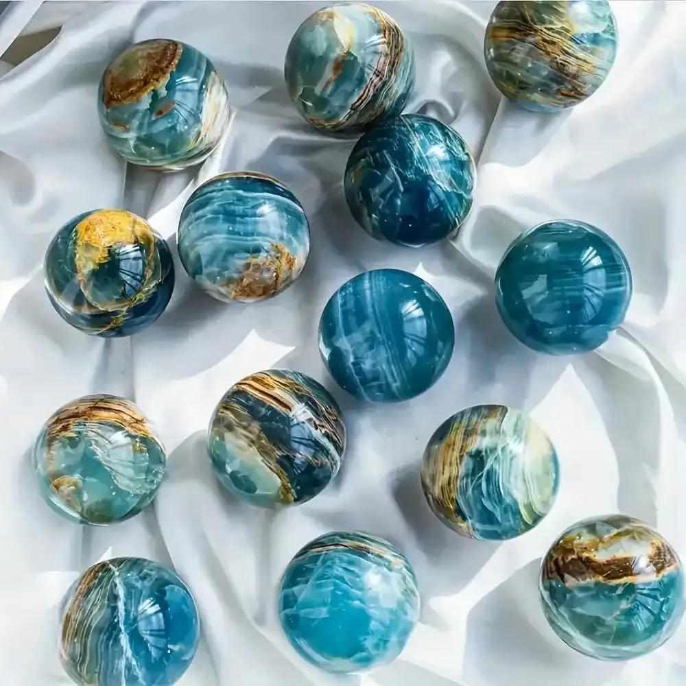 Polished Blue Onyx spheres featuring layered blue tones and natural bands for Throat and Third Eye chakra meditation.
