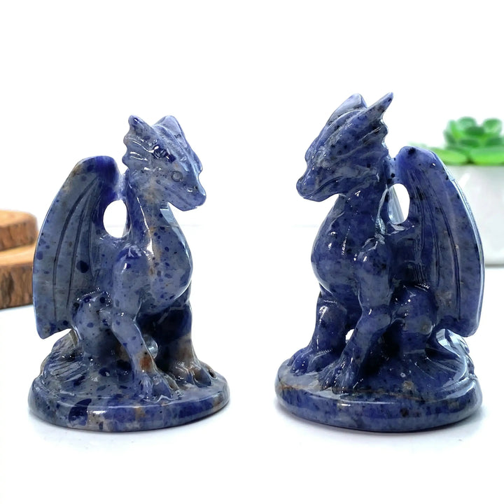 Two polished blue sodalite dragon carvings featuring intricate winged designs, perfect for Throat Chakra meditation.