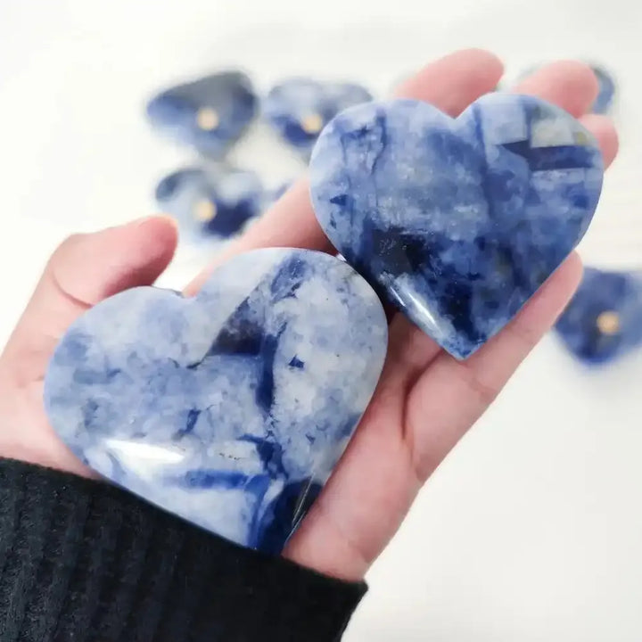 Polished Blue Sodalite heart stone with deep blue tones and white patterns, perfect for Throat Chakra healing and meditation.