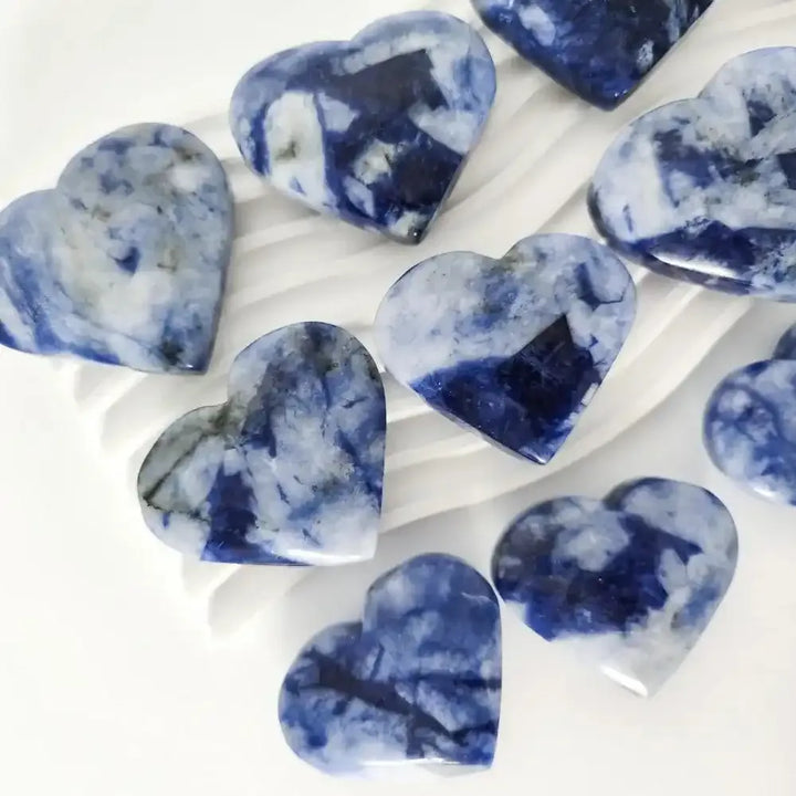 Polished Blue Sodalite hearts featuring rich blue tones and white patterns, perfect for Throat Chakra healing.