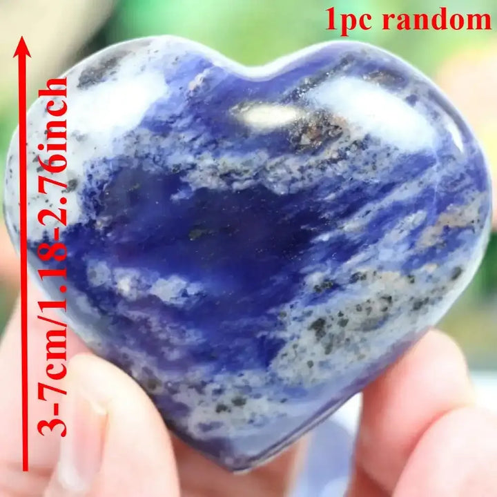 Polished blue sodalite heart stone with white patterns, perfect for Throat Chakra healing and mindful reflection.