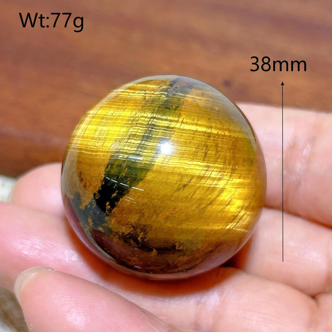 38mm natural yellow Tiger Eye crystal sphere, a polished healing stone ball with flashy chatoyant energy for home decor.