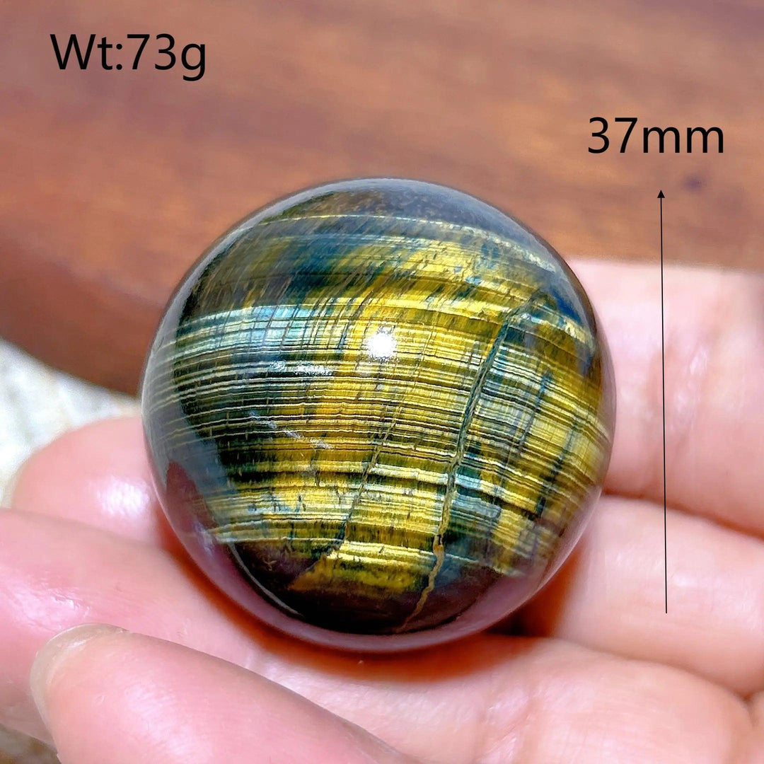 37mm blue and yellow Tiger Eye crystal sphere, a polished healing stone with flashy chatoyancy for home decor and energy.
