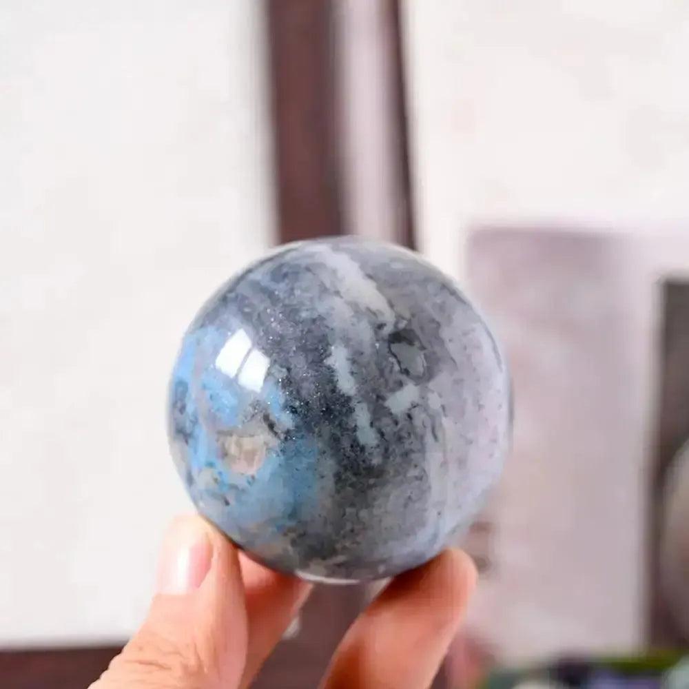 Polished Blue Trolleite sphere by Crystal Destiny, showcasing blue-gray hues for spiritual awakening and meditation.