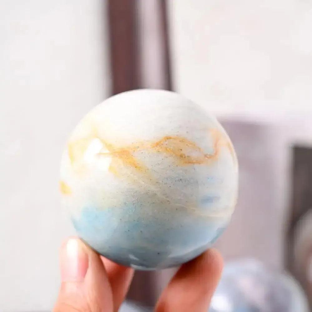 Polished Blue Trolleite sphere by Crystal Destiny, showcasing blue-gray and subtle golden hues for spiritual insight.