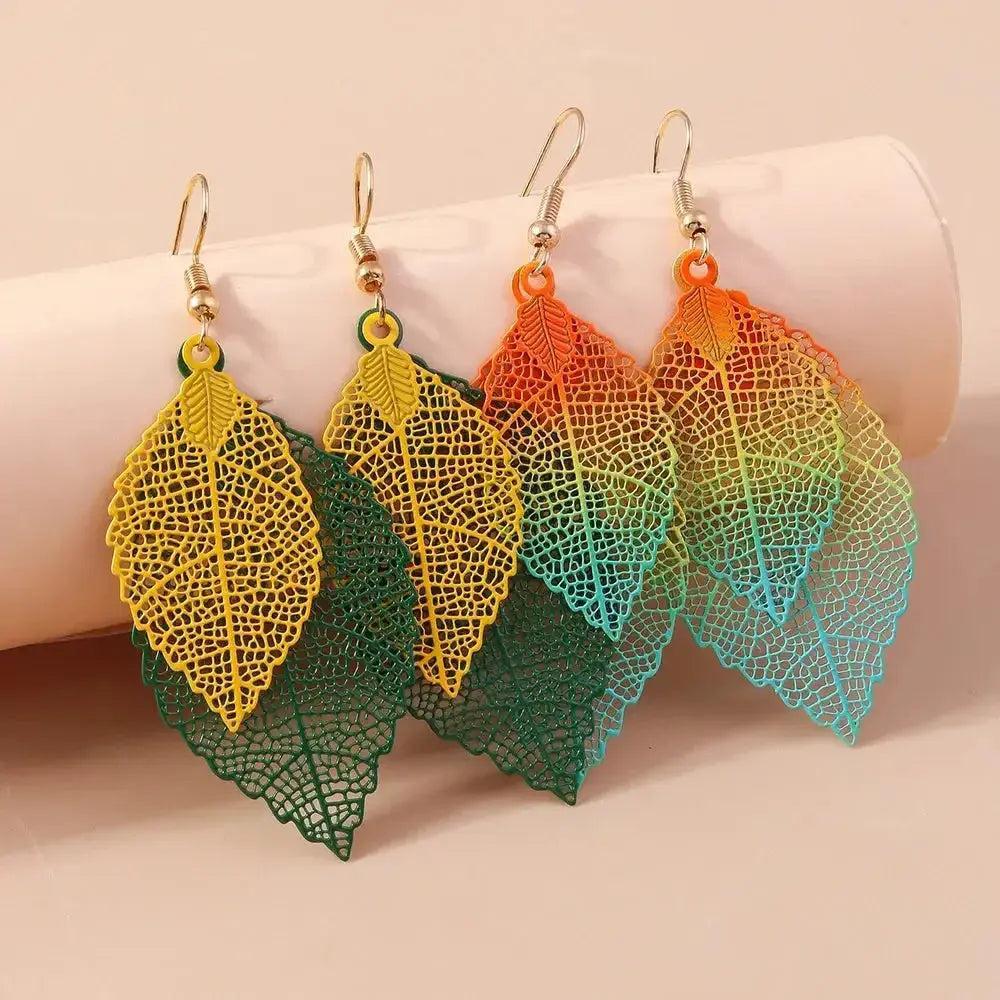Three pairs of colorful, hollow double leaf drop earrings in yellow, green, and ombre orange-teal.