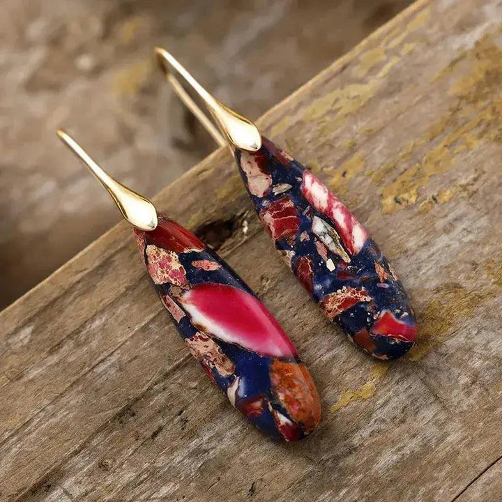 Bohemian Empire Jasper teardrop earrings by Crystal Destiny, featuring unique blue, red, and earthy patterns on gold hooks.