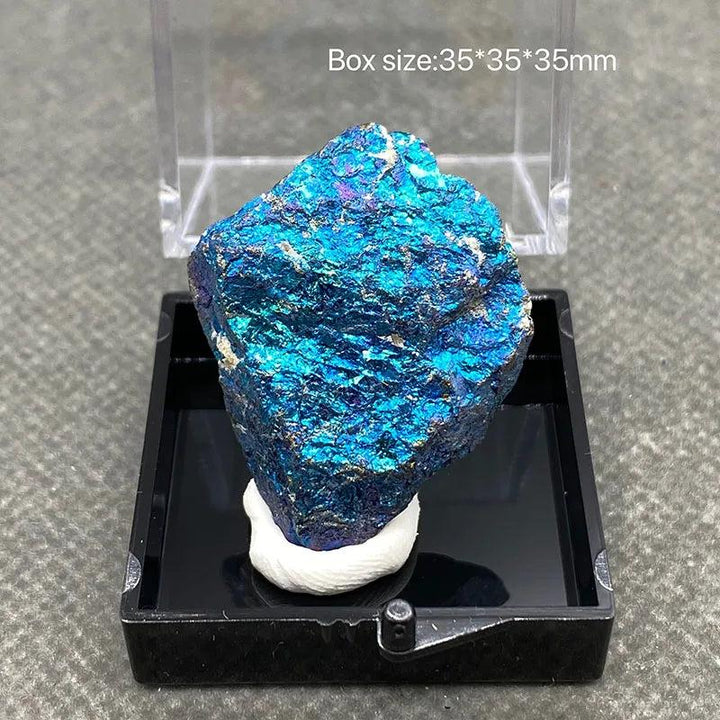 Raw Bornite Peacock Ore specimen with iridescent blue, purple, and gold hues and Pyrite inclusions in a display box.