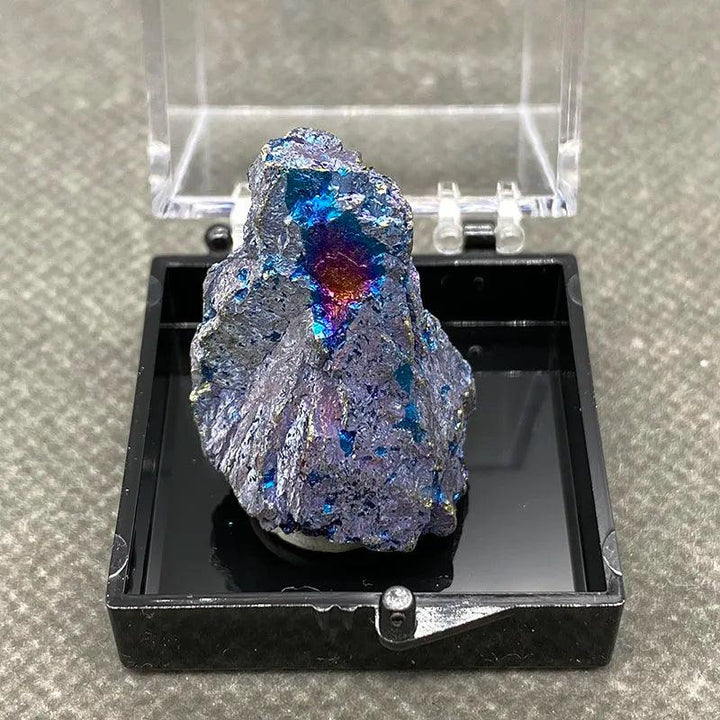 Raw Bornite Peacock Ore specimen with iridescent blue, purple, and gold hues and metallic Pyrite in a display box.