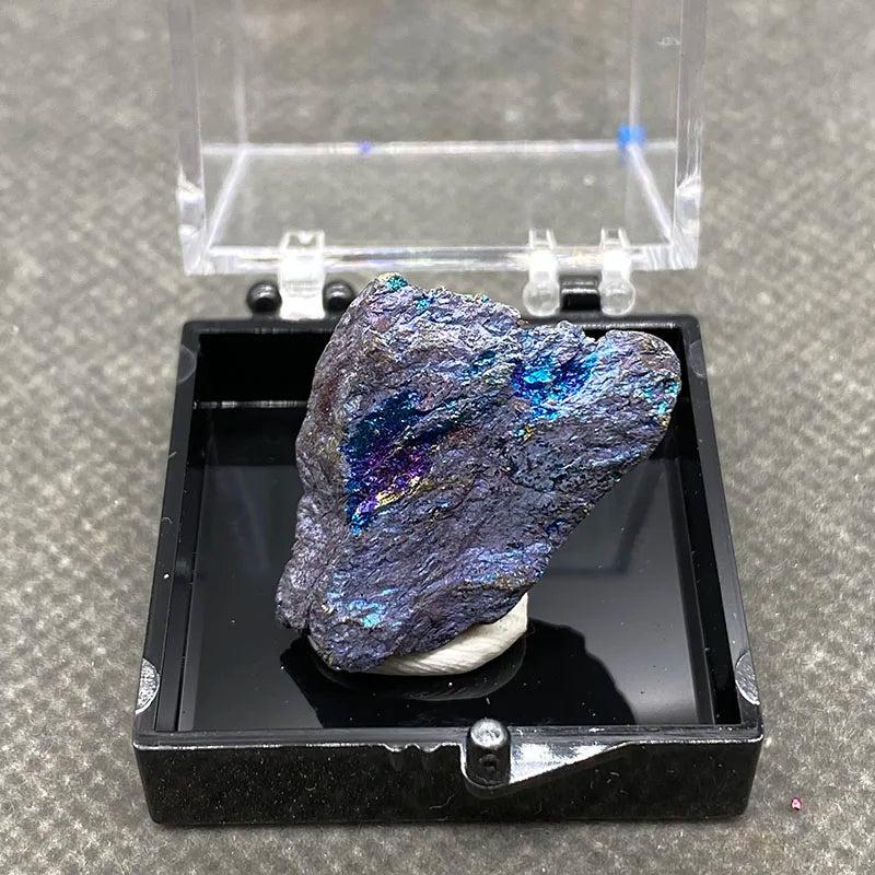 Raw Bornite Peacock Ore specimen with iridescent blue, purple, and gold shimmer in a display box for manifestation.