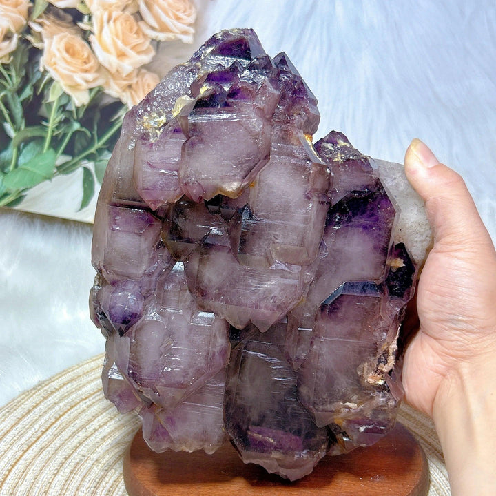 Large raw Brazilian amethyst skeletal elestial cluster with deep violet points and rare, layered, otherworldly geometry.