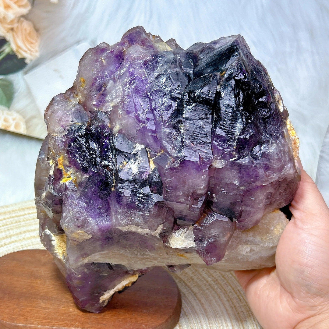 Large raw Brazilian amethyst skeletal elestial cluster with deep violet points and unique layered, stepped formations.