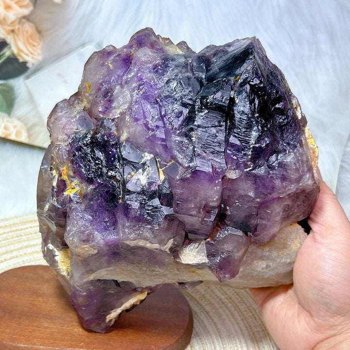 Large raw Brazilian amethyst skeletal elestial cluster with deep violet points and unique layered, stepped formations.