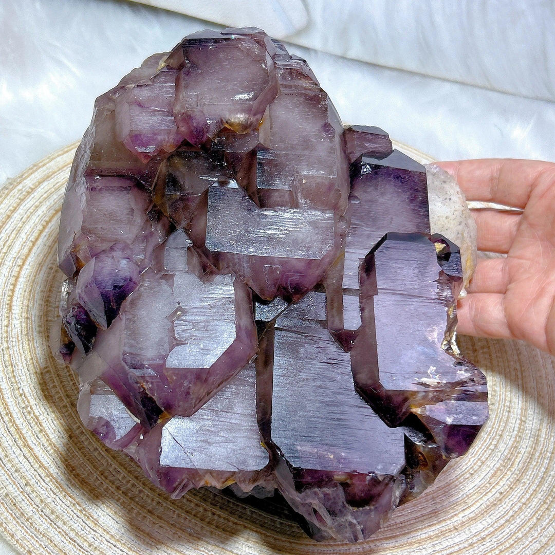 Large raw Brazilian amethyst skeletal elestial cluster with deep violet, stepped crystal points for calming energy.