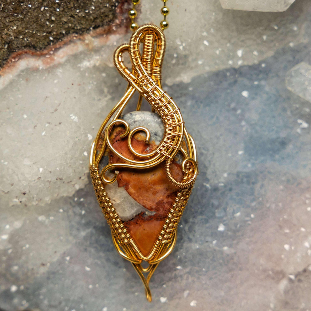 Brecciated Jasper wire wrap pendant with deep red, brown, and gray fragments in healing copper.