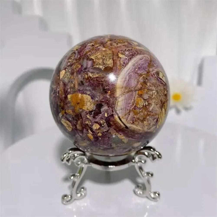 Grounding Brecciated Jasper crystal sphere with bold red, brown, and cream fractured patterns on a decorative stand.