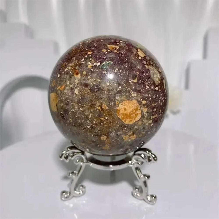 Polished Brecciated Jasper crystal sphere with grounding red, brown, and cream patterns on a decorative metal stand.