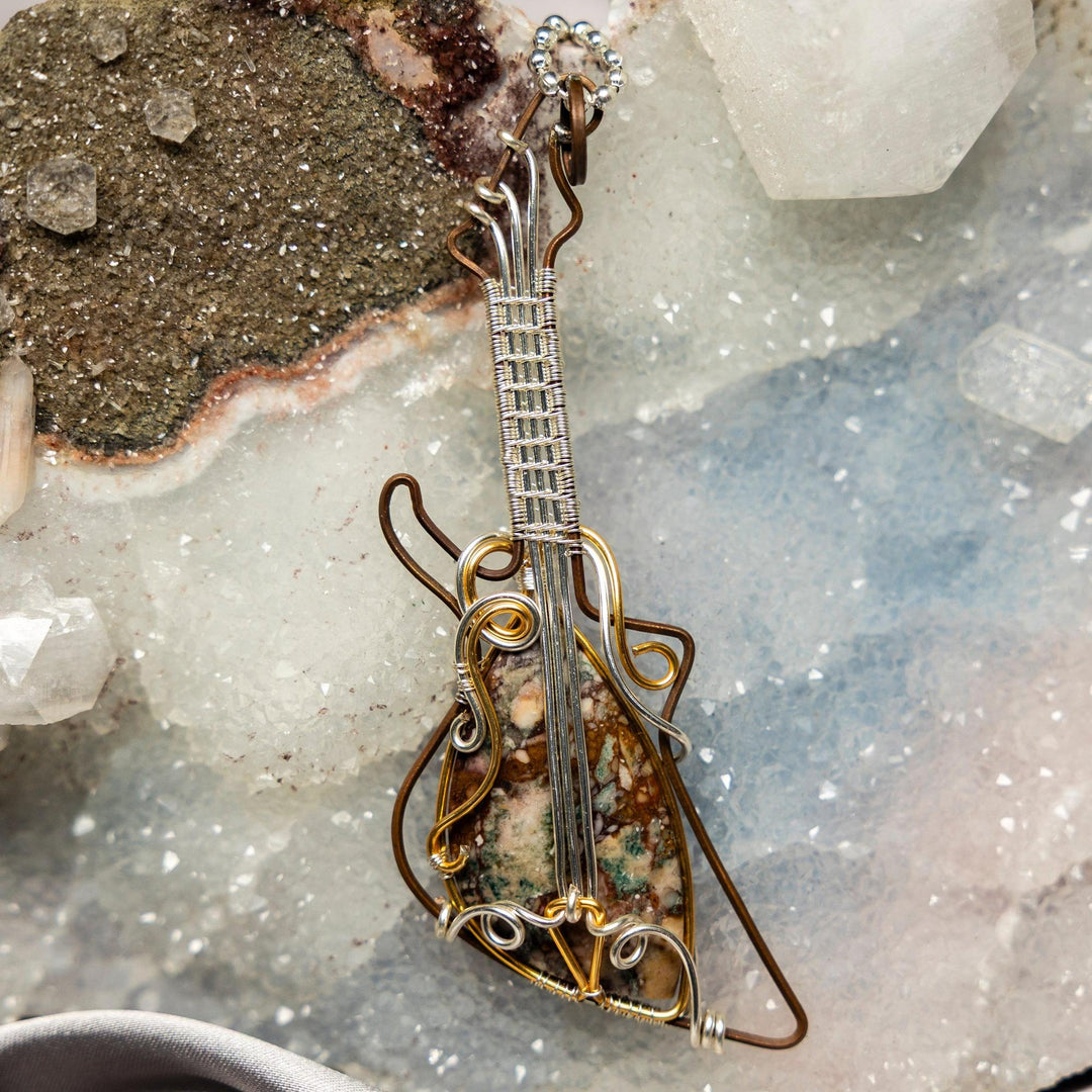 Brecciated Jasper Guitar Wire Wrap Pendant: Handcrafted copper and silver guitar with a unique red, brown, and grey jasper.