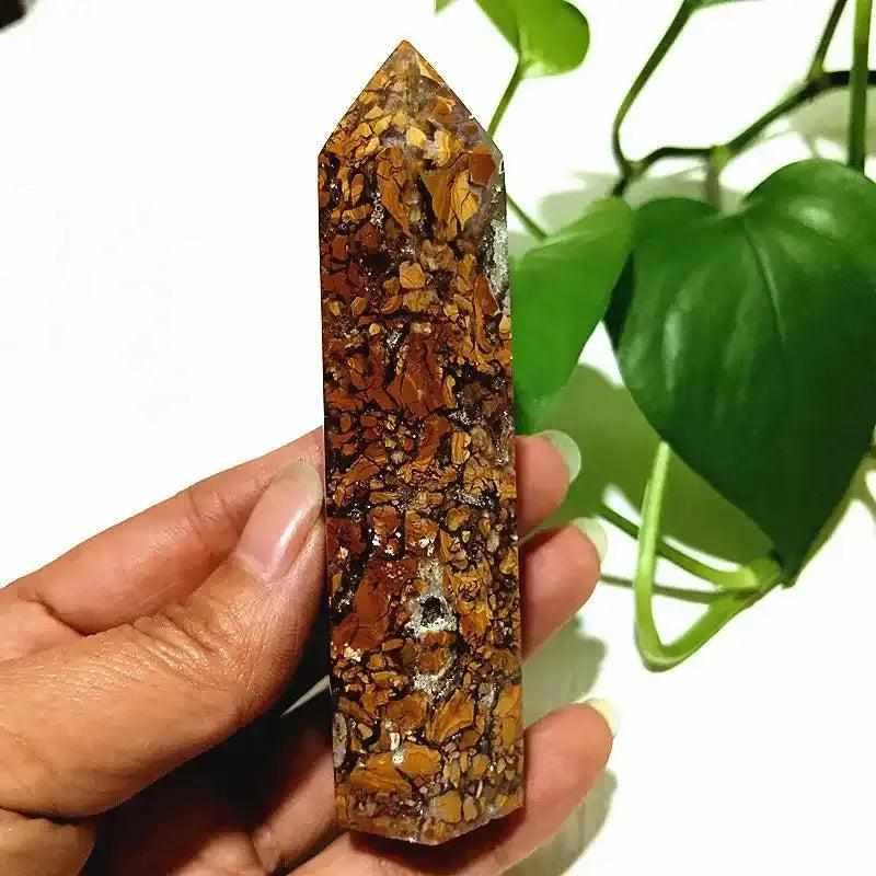 Polished Brecciated Jasper tower with red and brown mosaic patterns for grounding, held in hand as a crystal point.