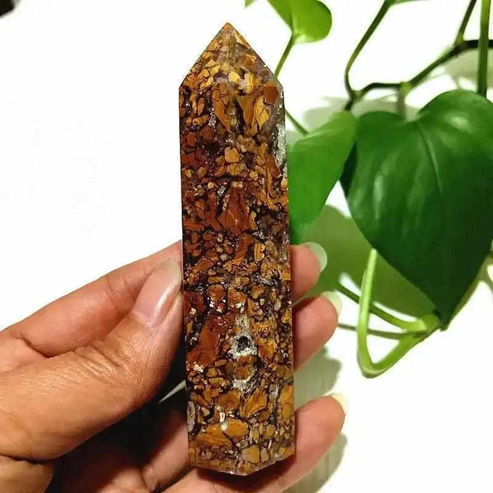 Polished Brecciated Jasper tower with red and brown mosaic patterns for grounding, held in hand as a crystal point.