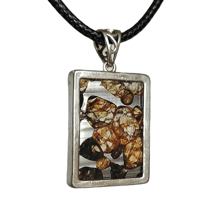 Brenham Meteorite pendant by Crystal Destiny, featuring olive-green peridot crystals in a rectangular sterling silver setting.