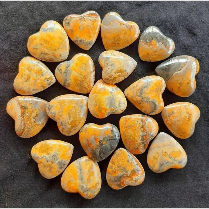 Vibrant Bumble Bee Jasper crystal hearts with bold yellow, orange, and black banding, igniting creativity and confidence.