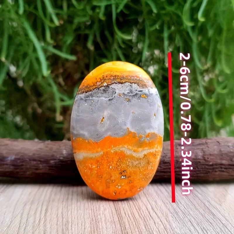 Vibrant orange and grey Beehive Crystal Palm stone, a healing bumblebee jasper pocket stone for energy.