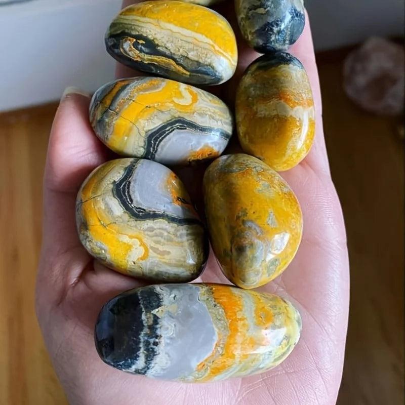 Polished Beehive Crystal Palm stones with vibrant yellow, grey, and black banding for healing energy.