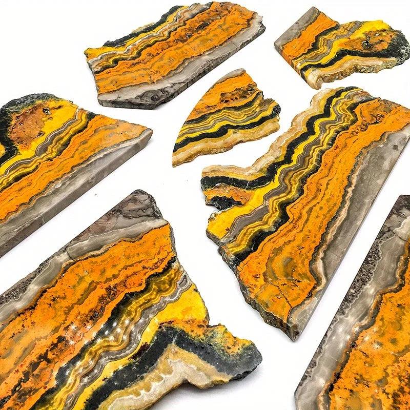 Polished Bumblebee Jasper crystal slabs with vibrant yellow, orange, and black banding for energy and confidence.