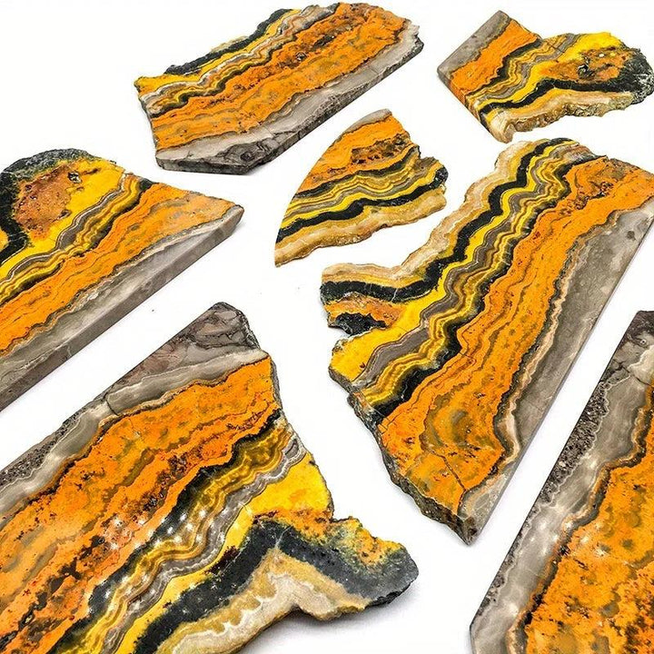 Polished Bumblebee Jasper crystal slabs with vibrant yellow, orange, and black banding for energy and confidence.