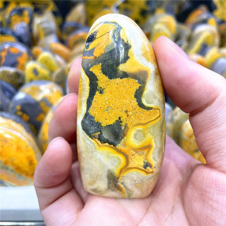 Polished Bumblebee Jasper freeform stone with vibrant yellow, orange, and black bands for solar plexus energy.