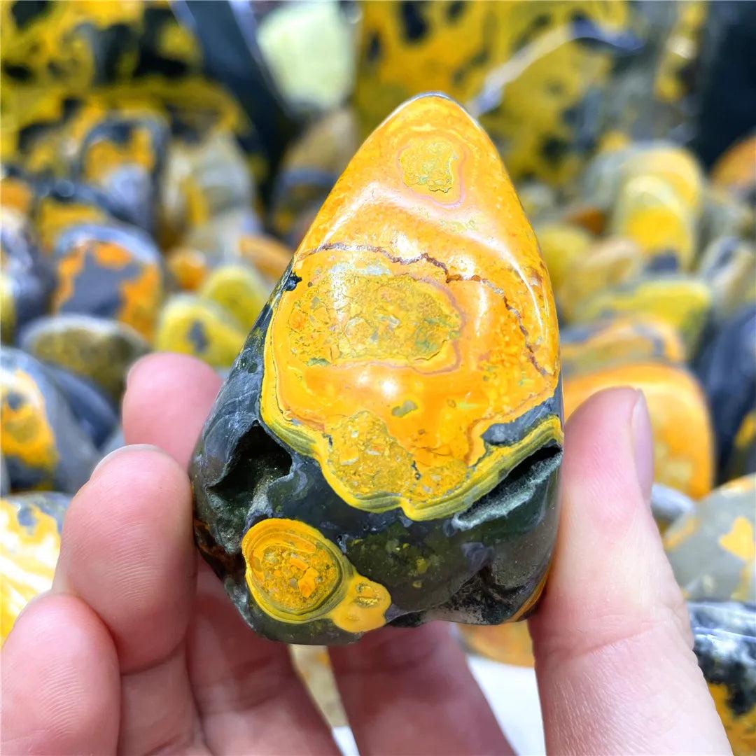 Polished Bumblebee Jasper freeform stone with vibrant yellow, orange, and black volcanic banding for solar plexus energy.