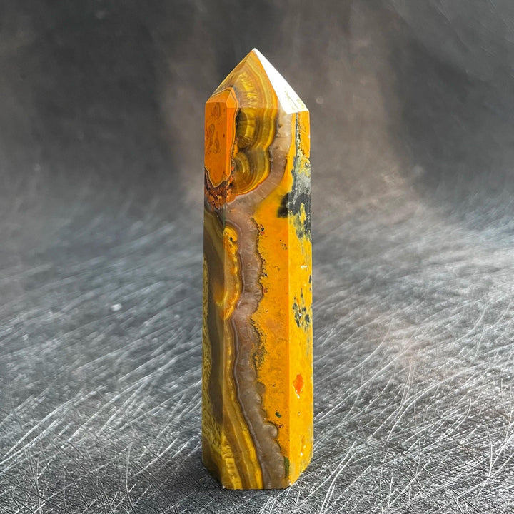 Bumblebee Jasper Crystal Tower with vibrant yellow, orange, and black bands for vitality.