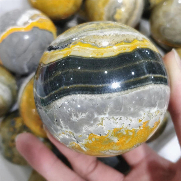 Bumblebee Jasper Crystal Sphere with vibrant yellow, black, and grey bands for solar plexus energy.