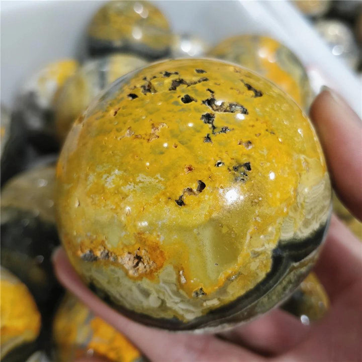 Vibrant yellow and black Bumblebee Jasper Crystal Sphere for solar plexus chakra healing.