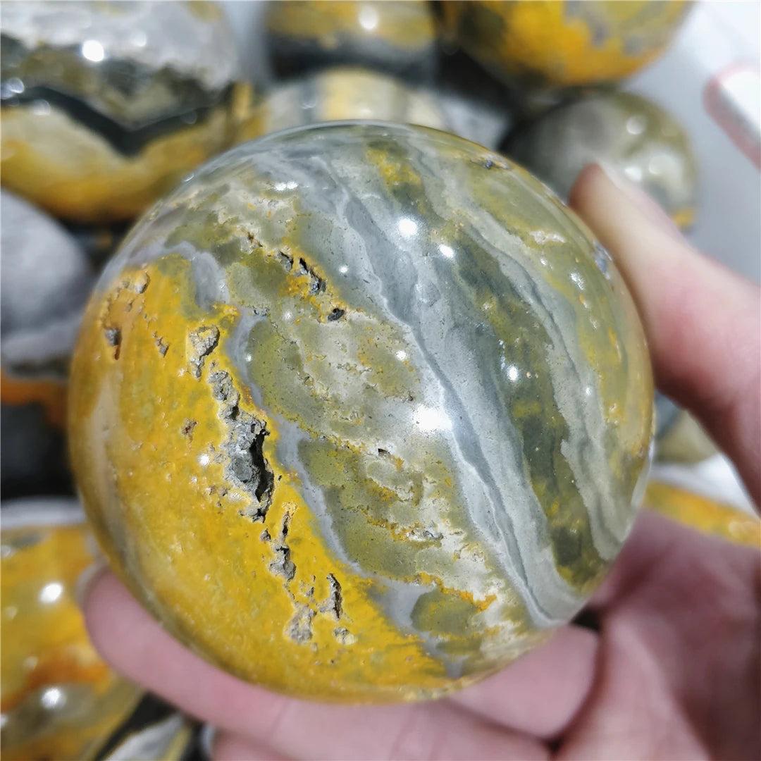 Bumblebee Jasper Crystal Sphere with yellow, grey, and black volcanic bands for solar plexus energy.