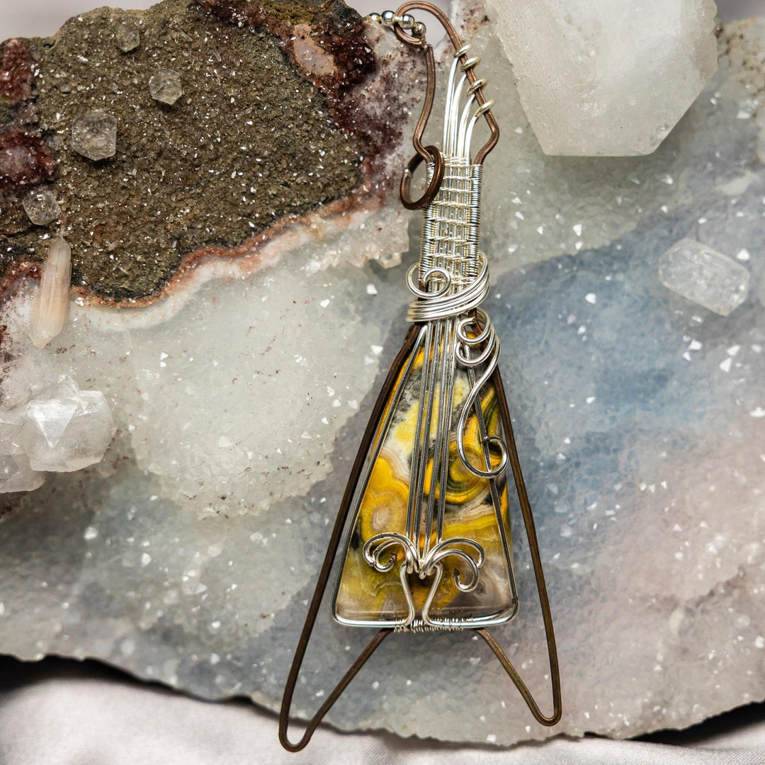 Bumblebee Jasper Crystal Wire Wrap Pendant: Copper guitar with vibrant yellow, orange, black, and white stone.