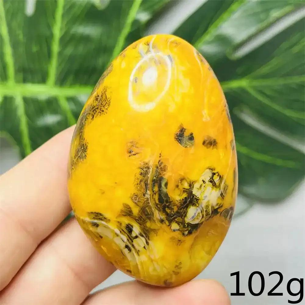 Smooth Bumblebee Jasper palm stone featuring vibrant yellow, orange, and black stripes for optimism and solar plexus energy.